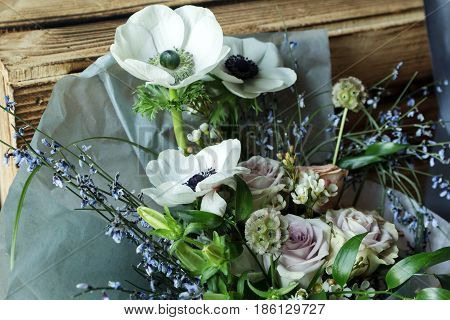 Flower arrangement with branches of a pistachio branches of Ruscus, carnations, roses, branch of Brunei, berries of Hypericum. Wedding concept