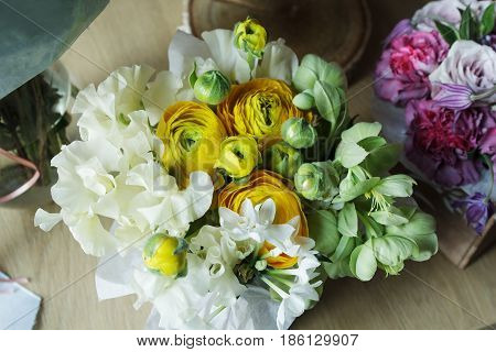 Flower arrangement with branches of a pistachio branches of Ruscus, carnations, roses, branch of Brunei, berries of Hypericum. Wedding concept