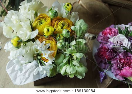 Flower arrangement with branches of a pistachio branches of Ruscus, carnations, roses, branch of Brunei, berries of Hypericum. Wedding concept