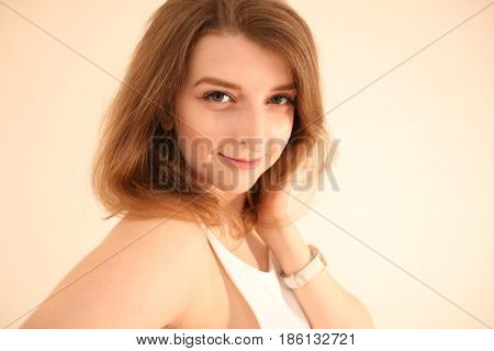 Portrait of attractive young woman with long brown hair posing isolated on white background. Perfect face for your company
