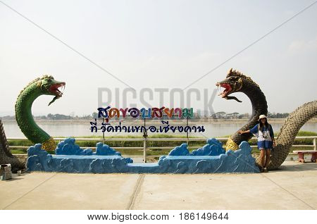 Travelers Thai Woman Visit And Posing For Take Photo With Black Naga Statue At Mae Khong Riverside