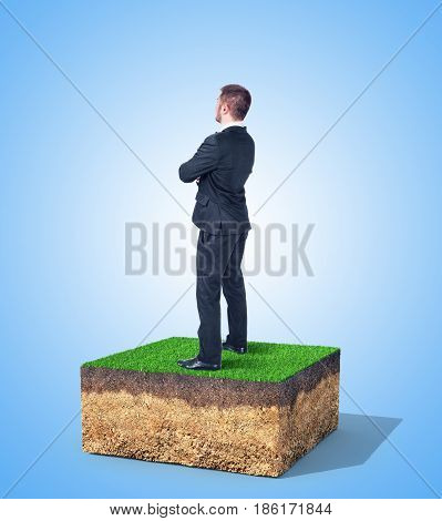 The concept of property. A man is standing on a piece of land.