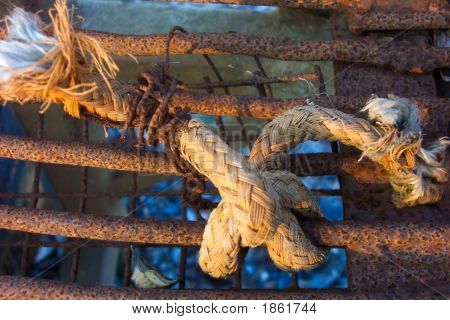 Knotted Old Rope On Rusty Machinery