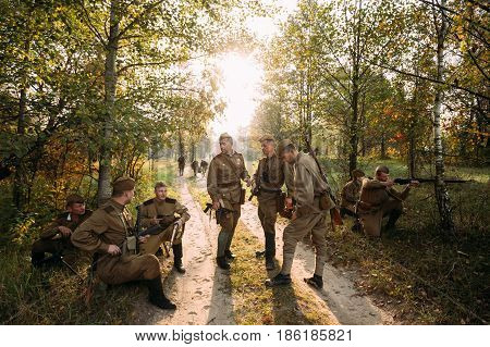 Dyatlovichi, Belarus - October 2, 2016: Re-enactors Dressed As Russian Soviet Red Army Soldiers Of World War II Briefs Before Attacking Enemy Positions In Autumn Forest During Historical Reenactment