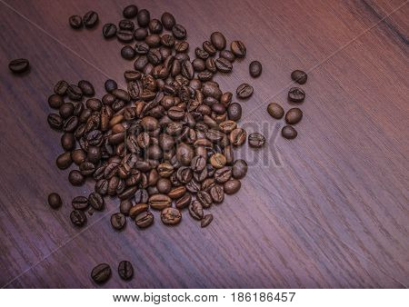 Beautiful coffee beans Fried coffee beans on a chocolate board.