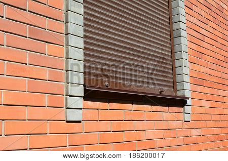 House window with Security Shutters Grilles. Security shutters roller shutters security gates retractable security. Window with rolling shutter for house protection.