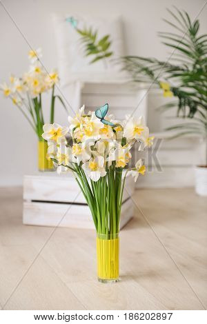 white daffodils with butterflies, spring background of flowers.