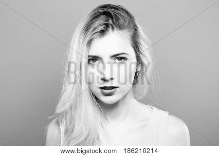 Black and White Portrait of Temperamental Sad Blonde with Long Hair Posing in Studio.