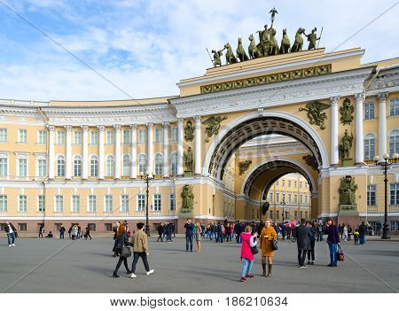 SAINT PETERSBURG RUSSIA - MAY 1 2017: Unknown people are walking along Palace Square near Arch of Main Staff St. Petersburg Russia