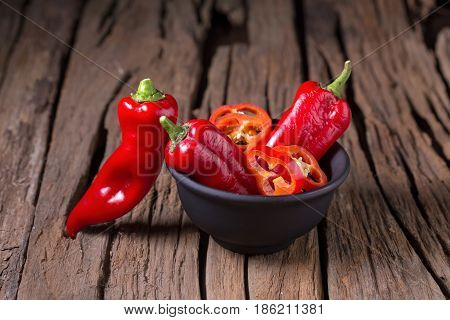 Red Chilly Pepper On Wooden Black Background. Red Hot Chili Peppers.