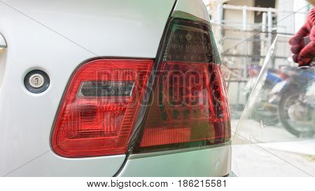 Car LED tail light  wrapped in adhesive foil or film by car wrapping professional