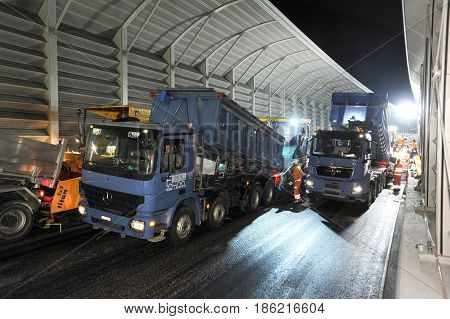Workers And Vehicles During The Asphalting Of The Highway