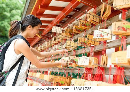 Fukuoka, Dazaifu Tenman-gu, Japan, September, 2016:- Woman wishing in Japanese temple