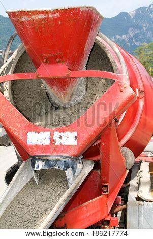 Bissone, Switzerland - 22 May 2009: Truck operator pouring cement into crane bucket with a cement truck mixer