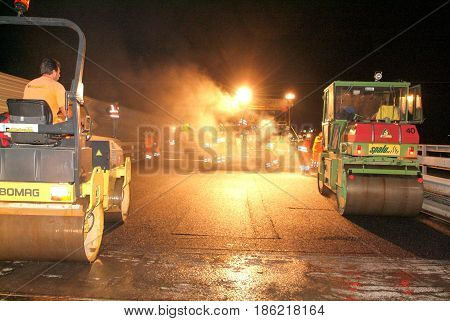 Workers And Vehicles During The Asphalting Of The Highway