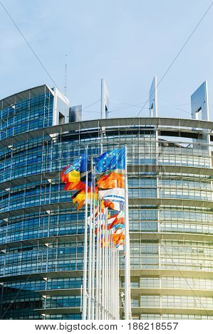 STRASBOURG FRANCE - MAR 31 2017: The European Parliament building in Strasbourg France with flags waving calmly celebrating peace of the Europe