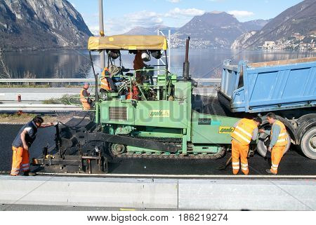 Workers And Vehicles During The Asphalting Of The Highway