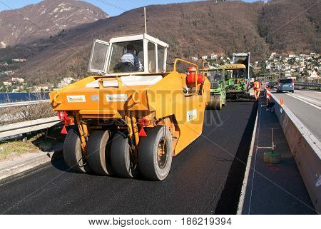 Workers And Vehicles During The Asphalting Of The Highway