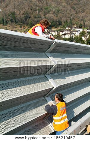 Workers During The Installation Of Noise Barriers On The Highway