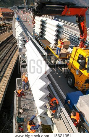 Workers During The Installation Of Noise Barriers On The Highway