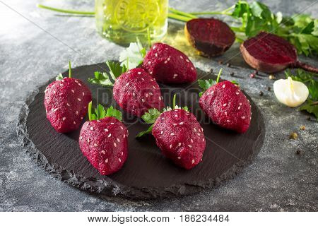 Vegan Strawberry Snack Of Boiled Beets Stuffed With Herring On A Slate Board. Healthy Eating Concept