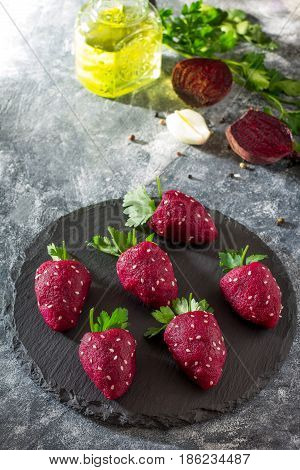 Vegan Strawberry Snack Of Boiled Beets Stuffed With Herring On A Slate Board. Healthy Eating Concept