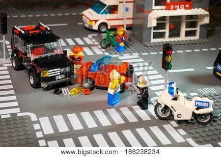 MOSCOW, DECEMBER 25, 2016: Lego City scene road accident - violation of traffic lights and regulations. Violation of traffic safety rule. Example for children. Ambulance police car bike