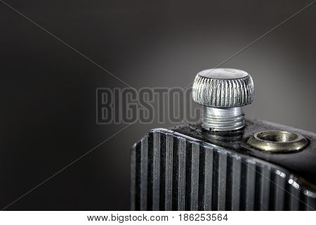 Cap and Grill.   A macro photograph of part of a 1940's sewing machine. Background layer in multiple business and industrial applications, advertising or as a  wall decoration in offices and hotels that cater to a business clientele.