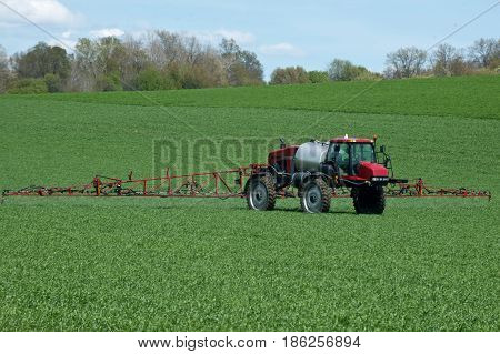 Tractor with agricultural sprayer machine for pesticide spraying