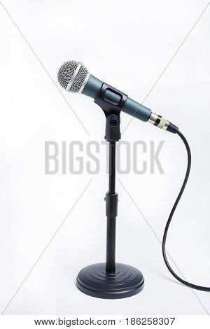 dynamic microphone on stand isolated on white background. Sound recording hardware audio equipment for studio and concert