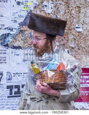 JERUSALEM - MARCH 13 : Ultra Orthodox man holding Mishloach Manot during Purim in Mea Shearim Jerusalem on March 13 2017 Mishloach Manot is traditional food gifts given during Purim