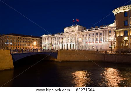 ST PETERSBURG, RUSSIA - MAY 03, 2017: View of the Blue bridge and the Mariinsky palace from the Moika River on the May night