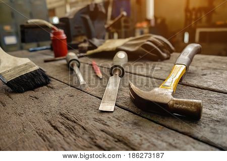 Inverted welding machine welding equipment on a wooden desk with workshop background welding mask leather gloves welding electrodes high-voltage wires with clips set of accessories for arc welding.