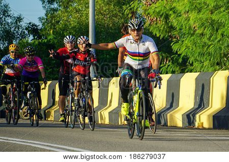 Labuan,Malaysia-May 10,2017:Group of cyclists enjoying cycling on a sunny day in Labuan island,Malaysia.Malaysia is encouraging people to cycle not just for recreation but to commute to work.