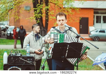 Russia Siberia Novokuznetsk - may 9 2017: musicians sing songs on the street on victory day