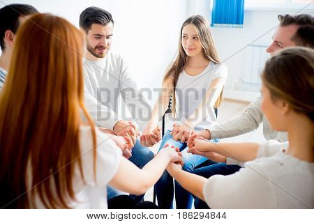 Group of friends holding hands together - unity concept