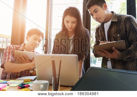 Young University Students Studying With Computer And Tablet In Cafe. Group Of People In Campus Libra