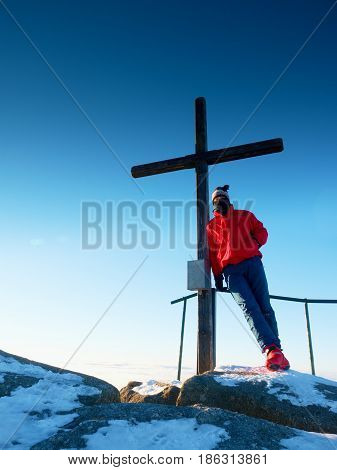 Tourist In Winter Clothes On Summit  With Crucifix