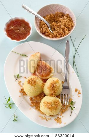 Dumpling with plum and buttered bread crumbs