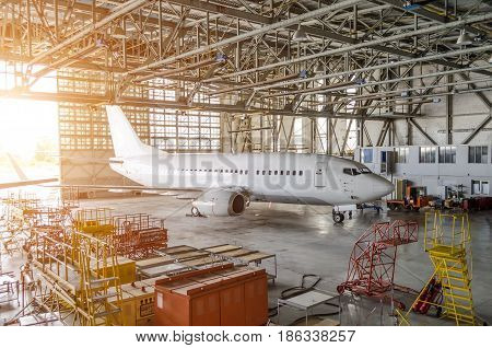 Airliner Aircraft In A Hangar With An Open Gate To The Service.