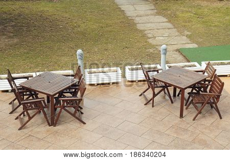 Winter near Mavrovo lake in Macedonian republic, two tables outside