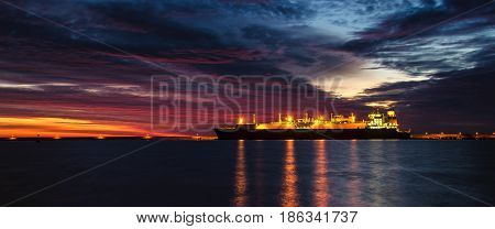 GAS CARRIER - Tanker at the wharf in the harbor at dawn