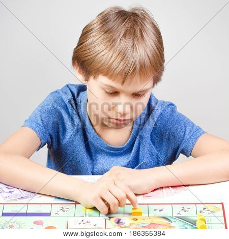 Little boy playing board game at home