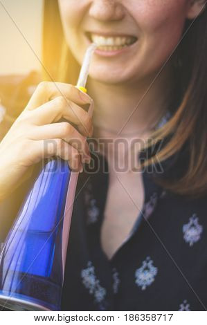 A Woman Using An Oral Irrigator In Bathroom. Selective Focus