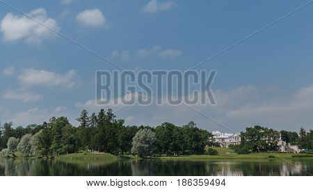 Beautiful Russian Landscape With Willows Near Water Of A Lake And Clouds In Blue Sky.