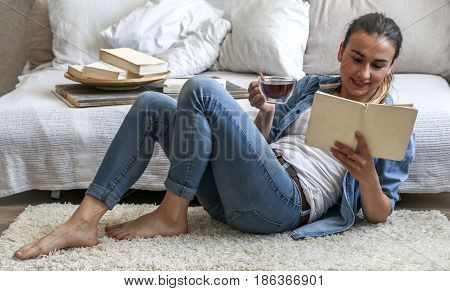 Girl Reading A Book In A Cozy Room