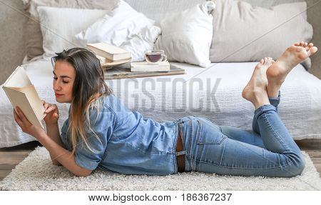 Girl Reading A Book In A Cozy Room