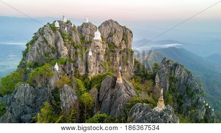 Aerial shot of the Chalermprakiat Prajomklao Rachanusorn chedis on the mountain top, Lampang province, Thailand