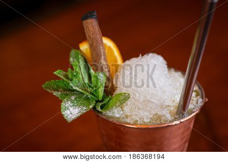 Cocktail. Mint Julep With Orange In Copper Glass And Steel Straw
