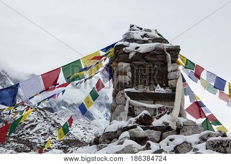 Everest Base Camp Trek/nepal - October 24, 2015: Buddhist Prayer Flags Under Snow On A Chorten Memor